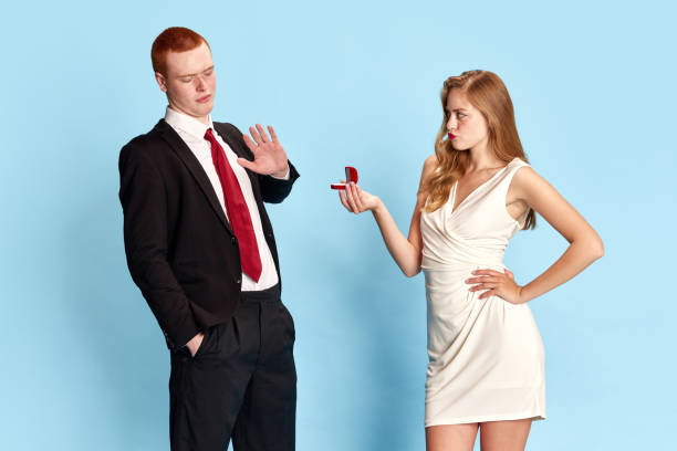 Beautiful young girl in white dress proposing to her boyfriend to get married