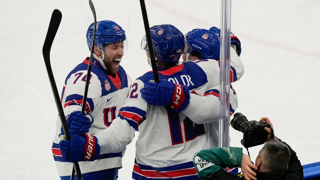 Matt Boldy (12) celebrates with Jaccob Slavin (74) and Brock Faber (14)