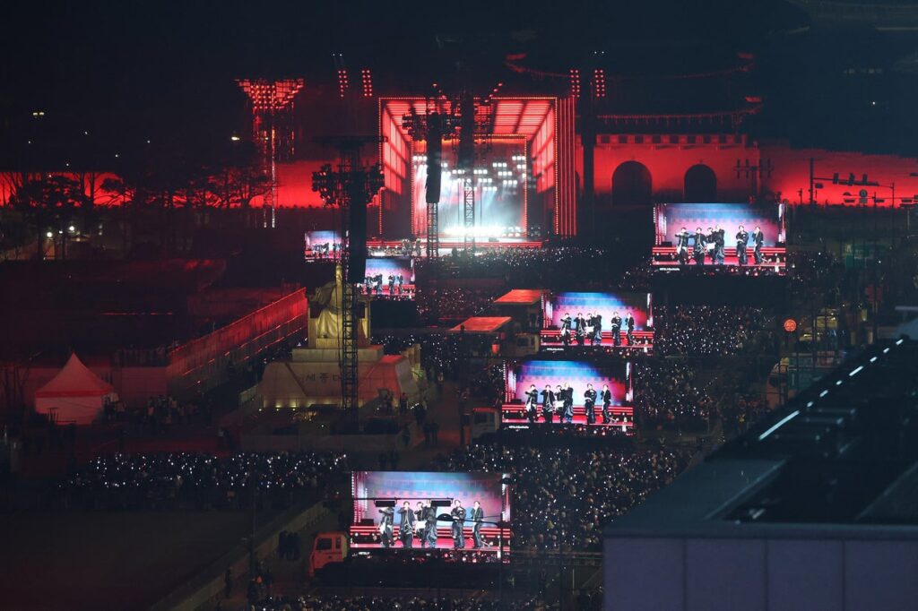 Fans of K-pop boy band BTS cheer during their comeback concert near Gwanghwamun Square on March 21